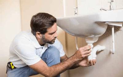 plumber fixing sink