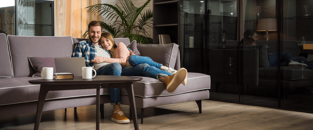 comfortable couple looking at laptop